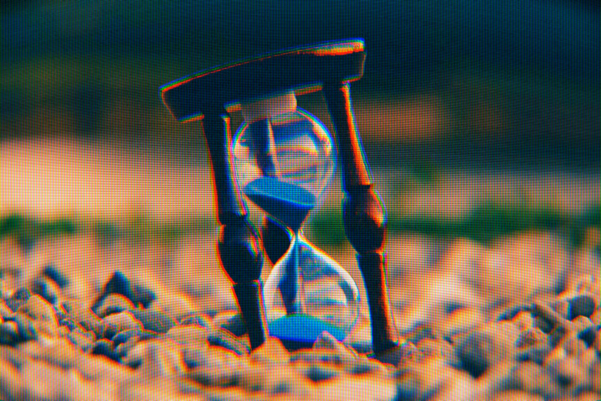 an hourglass on stones