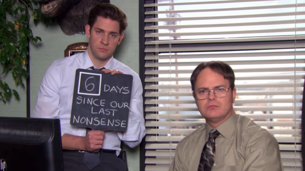 Jim Halpert holding a sign that reads '6 days since our last nonsense' next to a stern Dwight Schrute | Timestripe